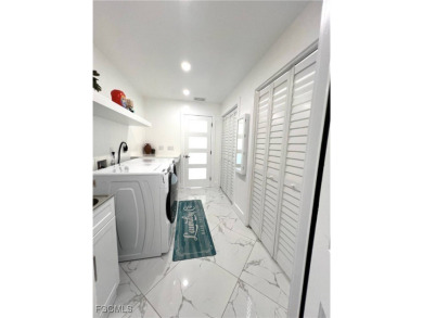 Modern Elegance Meets Florida Living in Imperial Golf Estates! on Imperial Golf Club in Florida - for sale on GolfHomes.com, golf home, golf lot