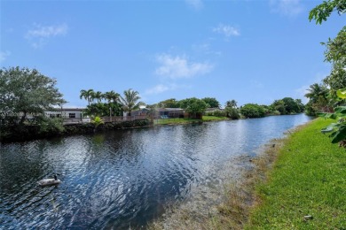 Welcome to your waterfront oasis in Sunrise Golf Village! This on Sunrise Lakes Phase III in Florida - for sale on GolfHomes.com, golf home, golf lot