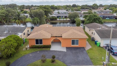 Welcome to your waterfront oasis in Sunrise Golf Village! This on Sunrise Lakes Phase III in Florida - for sale on GolfHomes.com, golf home, golf lot