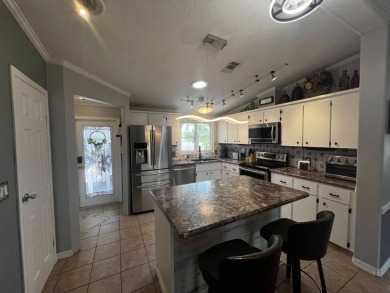 This beautifully updated 2-bedroom, 2-bathroom unfurnished home on Lake Henry Golf Club in Florida - for sale on GolfHomes.com, golf home, golf lot