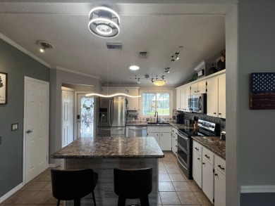 This beautifully updated 2-bedroom, 2-bathroom unfurnished home on Lake Henry Golf Club in Florida - for sale on GolfHomes.com, golf home, golf lot