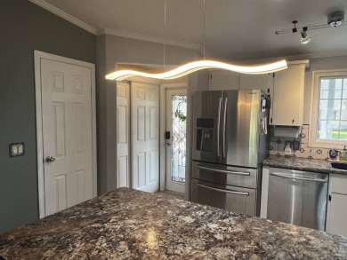 This beautifully updated 2-bedroom, 2-bathroom unfurnished home on Lake Henry Golf Club in Florida - for sale on GolfHomes.com, golf home, golf lot