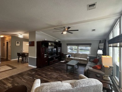 This beautifully updated 2-bedroom, 2-bathroom unfurnished home on Lake Henry Golf Club in Florida - for sale on GolfHomes.com, golf home, golf lot