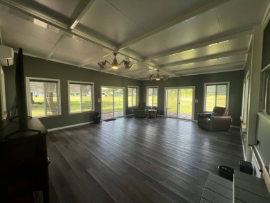 This beautifully updated 2-bedroom, 2-bathroom unfurnished home on Lake Henry Golf Club in Florida - for sale on GolfHomes.com, golf home, golf lot