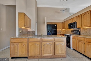 This bright, sunlit gem is situated overlooking a beautiful lake on Braelinn Golf Club in Georgia - for sale on GolfHomes.com, golf home, golf lot