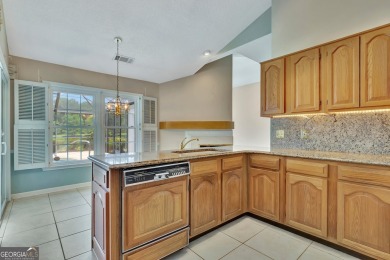 This bright, sunlit gem is situated overlooking a beautiful lake on Braelinn Golf Club in Georgia - for sale on GolfHomes.com, golf home, golf lot