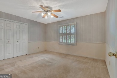 This bright, sunlit gem is situated overlooking a beautiful lake on Braelinn Golf Club in Georgia - for sale on GolfHomes.com, golf home, golf lot
