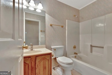 This bright, sunlit gem is situated overlooking a beautiful lake on Braelinn Golf Club in Georgia - for sale on GolfHomes.com, golf home, golf lot
