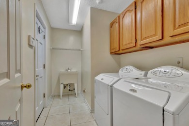 This bright, sunlit gem is situated overlooking a beautiful lake on Braelinn Golf Club in Georgia - for sale on GolfHomes.com, golf home, golf lot