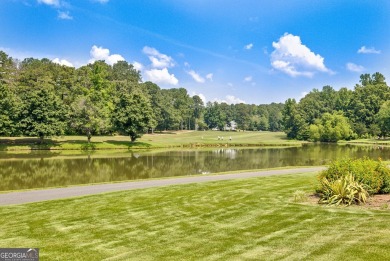 This bright, sunlit gem is situated overlooking a beautiful lake on Braelinn Golf Club in Georgia - for sale on GolfHomes.com, golf home, golf lot