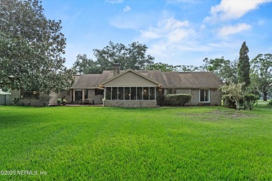 Timeless and inviting, this all-brick, one-level home is nestled on The Deerwood Country Club in Florida - for sale on GolfHomes.com, golf home, golf lot