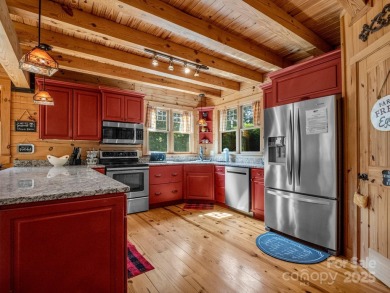 Classic log cabin, conveniently located behind the gates of on Rumbling Bald Resort on Lake Lure in North Carolina - for sale on GolfHomes.com, golf home, golf lot