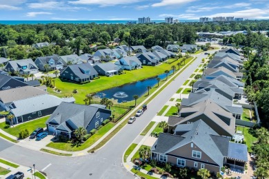 Relax on the welcoming front porch and soak up the sunshine in on Surf Golf and Beach Club in South Carolina - for sale on GolfHomes.com, golf home, golf lot