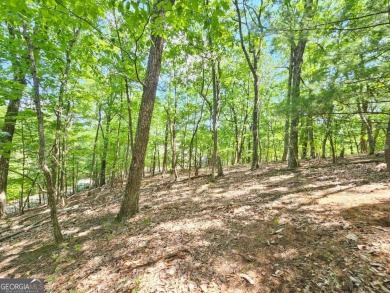 Nestled within the serene and exclusive Big Canoe community in on Big Canoe Golf Club - Cherokee in Georgia - for sale on GolfHomes.com, golf home, golf lot