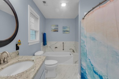Charming waterview retreat! Welcome to 901 Caracara Drive a on Harbour Point Golf Club in North Carolina - for sale on GolfHomes.com, golf home, golf lot