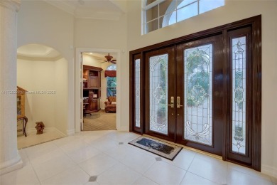 Discover this exquisite 4-bed 3.5-bath w/office & den pool home on Weston Hills Country Club in Florida - for sale on GolfHomes.com, golf home, golf lot