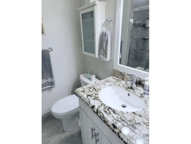 A most desirable waterfront location near pooles beautifully on Hillsboro Pines Golf in Florida - for sale on GolfHomes.com, golf home, golf lot