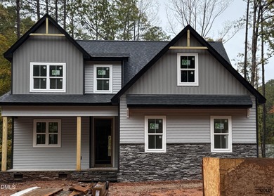 Experience the ultimate resort lifestyle in this move-in ready on River Golf and Country Club at Lake Royale in North Carolina - for sale on GolfHomes.com, golf home, golf lot