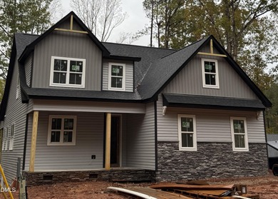 Experience the ultimate resort lifestyle in this move-in ready on River Golf and Country Club at Lake Royale in North Carolina - for sale on GolfHomes.com, golf home, golf lot