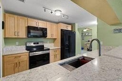 Don't miss this 1st floor unit on the 3rd hole of Gator Trace on Gator Trace Golf and Country Club in Florida - for sale on GolfHomes.com, golf home, golf lot
