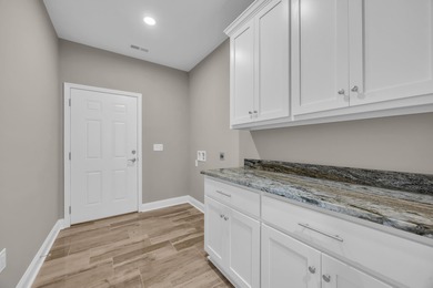 This brand-new, all-brick beauty delivers standout design on Long Bay Club in South Carolina - for sale on GolfHomes.com, golf home, golf lot