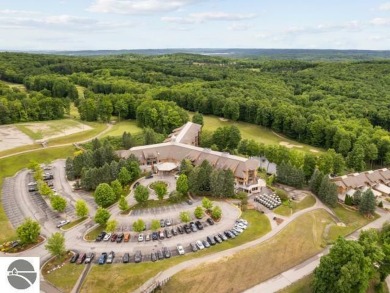 This second-floor Lodge suite offers picturesque views of both on Cedar River Golf Course in Michigan - for sale on GolfHomes.com, golf home, golf lot