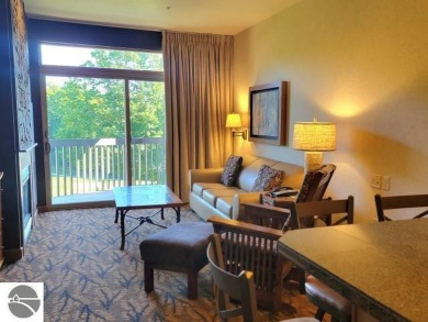 This second-floor Lodge suite offers picturesque views of both on Cedar River Golf Course in Michigan - for sale on GolfHomes.com, golf home, golf lot