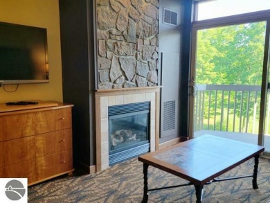 This second-floor Lodge suite offers picturesque views of both on Cedar River Golf Course in Michigan - for sale on GolfHomes.com, golf home, golf lot