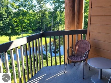 This second-floor Lodge suite offers picturesque views of both on Cedar River Golf Course in Michigan - for sale on GolfHomes.com, golf home, golf lot