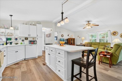 This sweet coastal cottage is move in ready. Sit on the screened on Sea Trail Golf Resort in North Carolina - for sale on GolfHomes.com, golf home, golf lot