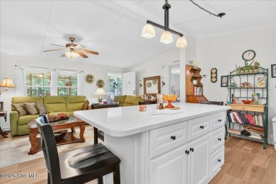 This sweet coastal cottage is move in ready. Sit on the screened on Sea Trail Golf Resort in North Carolina - for sale on GolfHomes.com, golf home, golf lot