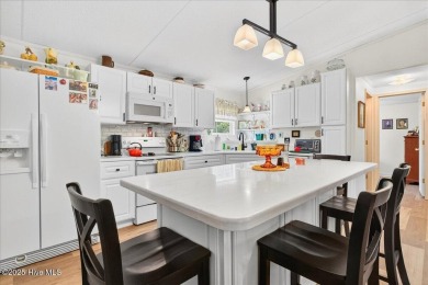 This sweet coastal cottage is move in ready. Sit on the screened on Sea Trail Golf Resort in North Carolina - for sale on GolfHomes.com, golf home, golf lot