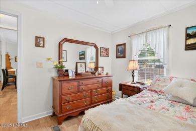 This sweet coastal cottage is move in ready. Sit on the screened on Sea Trail Golf Resort in North Carolina - for sale on GolfHomes.com, golf home, golf lot
