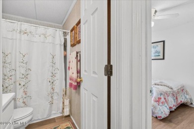 This sweet coastal cottage is move in ready. Sit on the screened on Sea Trail Golf Resort in North Carolina - for sale on GolfHomes.com, golf home, golf lot