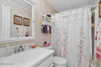 This sweet coastal cottage is move in ready. Sit on the screened on Sea Trail Golf Resort in North Carolina - for sale on GolfHomes.com, golf home, golf lot