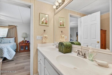 This sweet coastal cottage is move in ready. Sit on the screened on Sea Trail Golf Resort in North Carolina - for sale on GolfHomes.com, golf home, golf lot