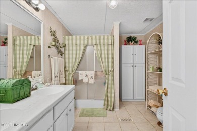 This sweet coastal cottage is move in ready. Sit on the screened on Sea Trail Golf Resort in North Carolina - for sale on GolfHomes.com, golf home, golf lot