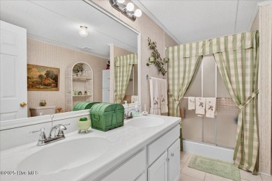 This sweet coastal cottage is move in ready. Sit on the screened on Sea Trail Golf Resort in North Carolina - for sale on GolfHomes.com, golf home, golf lot
