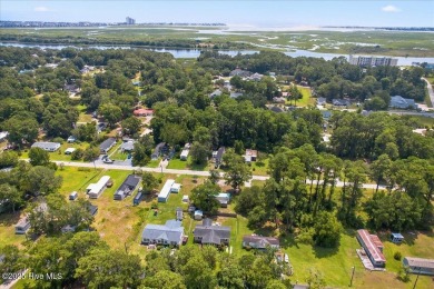 This sweet coastal cottage is move in ready. Sit on the screened on Sea Trail Golf Resort in North Carolina - for sale on GolfHomes.com, golf home, golf lot