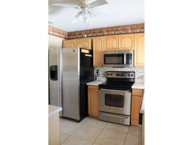 This single-family home, on a corner lot, located in Mainlands on Mainlands Golf Club in Florida - for sale on GolfHomes.com, golf home, golf lot