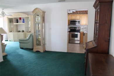 This single-family home, on a corner lot, located in Mainlands on Mainlands Golf Club in Florida - for sale on GolfHomes.com, golf home, golf lot