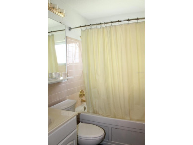 This single-family home, on a corner lot, located in Mainlands on Mainlands Golf Club in Florida - for sale on GolfHomes.com, golf home, golf lot