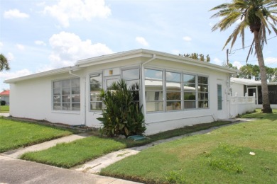 This single-family home, on a corner lot, located in Mainlands on Mainlands Golf Club in Florida - for sale on GolfHomes.com, golf home, golf lot