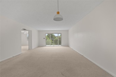 Experience the vibrant, active South Florida lifestyle in this on Wynmoor Golf Course in Florida - for sale on GolfHomes.com, golf home, golf lot