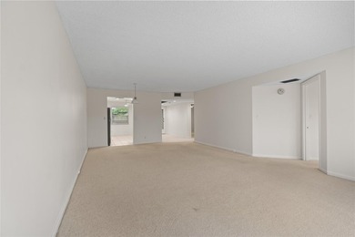 Experience the vibrant, active South Florida lifestyle in this on Wynmoor Golf Course in Florida - for sale on GolfHomes.com, golf home, golf lot