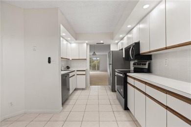 Experience the vibrant, active South Florida lifestyle in this on Wynmoor Golf Course in Florida - for sale on GolfHomes.com, golf home, golf lot