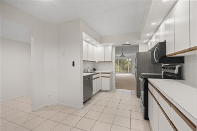 Experience the vibrant, active South Florida lifestyle in this on Wynmoor Golf Course in Florida - for sale on GolfHomes.com, golf home, golf lot