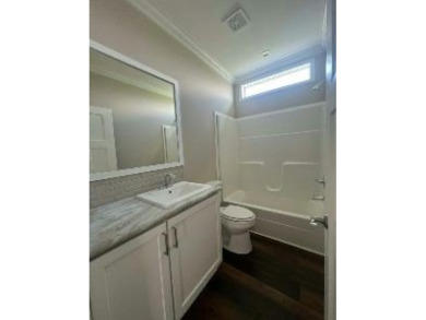 This New Palm Harbor Carriage Farmhouse home is 1500 Sq Ft and on Scotland Yards Golf Club in Florida - for sale on GolfHomes.com, golf home, golf lot