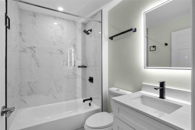 Discover the charm and elegance of this beautifully updated home on Arlington Ridge Golf Club in Florida - for sale on GolfHomes.com, golf home, golf lot