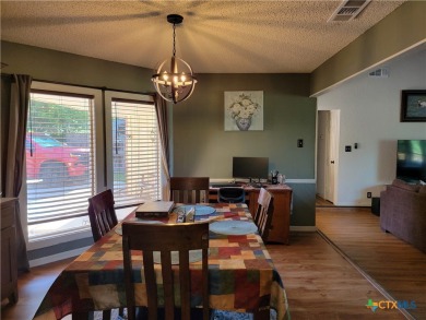 Enjoy a large main living room with a wood-burning fireplace on Hills of Cove Municipal Golf Course in Texas - for sale on GolfHomes.com, golf home, golf lot